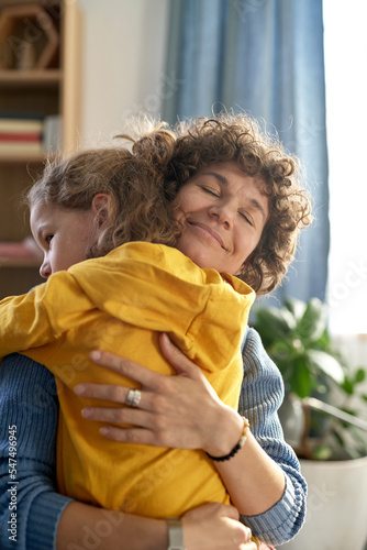 Bild auf Leinwand Happy mother embracing with her son and showing him all her love