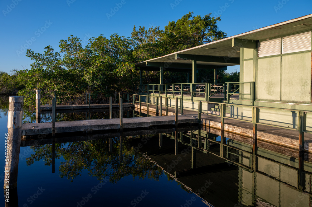 Visitor Facilities including picnic tables, restrooms, docks, boat ramps at West Lake in Everglades National Park, Florida on clear sunny autumn day. Visitor Facilities including picnic tables, restrooms, docks, boat ramps at West Lake in Everglades National Park, Florida on clear sunny autumn day.