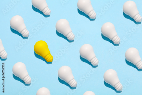 light bulb success business ideas creativity and inspiration concepts on blue background. Goal achievements flat lay minimalist composition