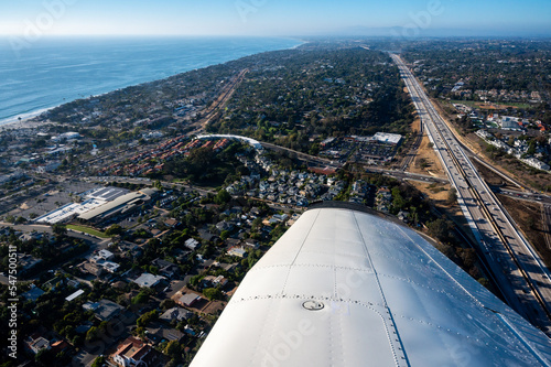 Aerial view of automobiles on Interstate 5 by Encinitas in San Diego California on a clear day with the Pacific ocean in the background