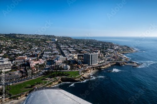 Aerial image of Children's Pool in La Jolla San Diego California with airplane wing in the foreground