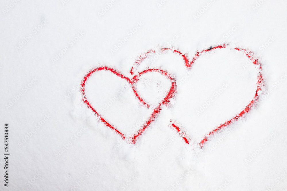 Two hearts symbol of love hand drawing painted on snow on the red car. Valentines day, love, honeymoon, winter, transport concept. Copy space. Two hearts symbol of love hand drawing painted on snow on the red car. Valentines day, love, honeymoon, winter, transport concept. Copy space.