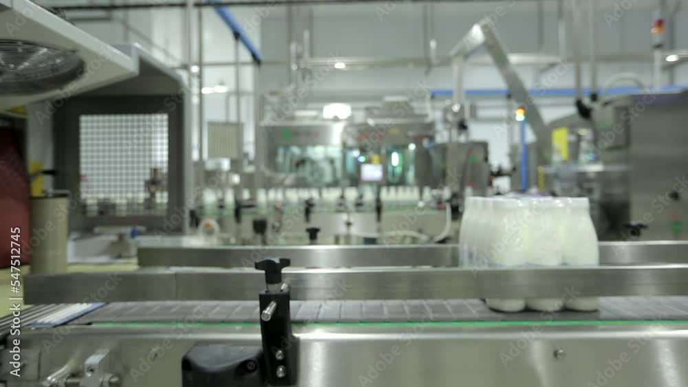 Conveyor Package distribution mechanism at industrial factory. Conveyor Distribution mechanism carrying multiple white packages. Conveyor Distribution mechanism transporting blank cardboard packages. Conveyor Package distribution mechanism at industrial factory. Conveyor Distribution mechanism carrying multiple white packages. Conveyor Distribution mechanism transporting blank cardboard packages.