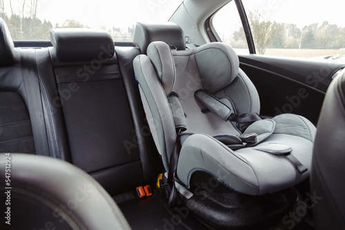 Child car seat for safety in the rear passenger seat of a car photo