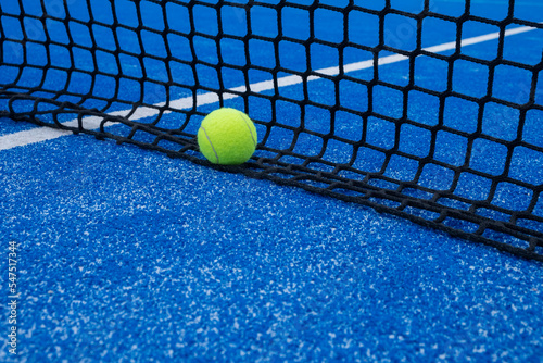 paddle tennis ball by the net of a paddle tennis court © Vic