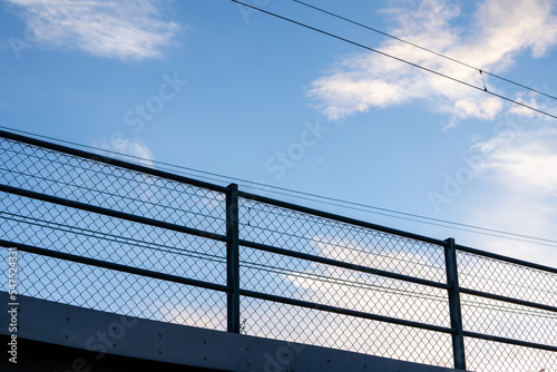 blue beautiful bright sky with a metal railing visible below it