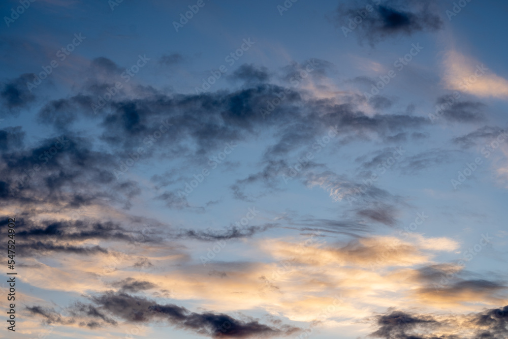 Bright blue cool autumn sky with light airy transparent clouds where some dark dramatic clouds create an eerie landscape Bright blue cool autumn sky with light airy transparent clouds where some dark dramatic clouds create an eerie landscape