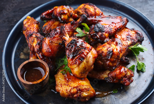 Quadro su tela Traditional barbecue chicken wings and drumsticks with hot chili mango sauce and