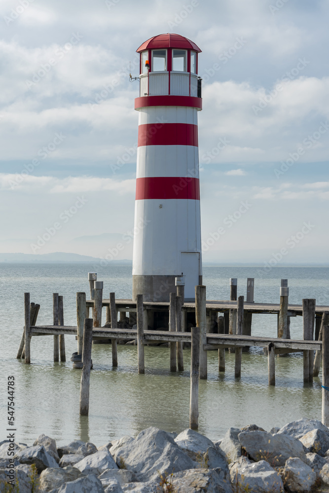 An old lighthouse for ships on the background of the sea surface