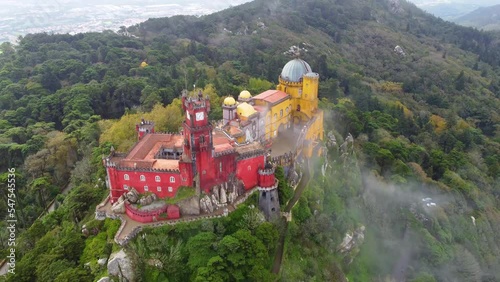 Aerial drone view of Park and National Palace of Pena in Sintra, Portugal during a magical day. Unesco. Historic visits. Sightseeing. Fairytale. Best destinations in the world. Most visited places. 
