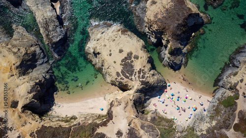 Aerial drone view of busy Beach in Algarve, Portugal during summer holidays. Amazing destinations. Travel and adventure. Vacations on the seaside. Exotic traveling. Most visited places. 