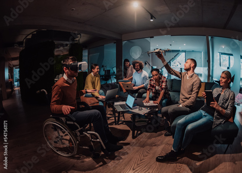 Business persons with a disability at work in modern open space coworking office on team meeting using virtual reality goggles.