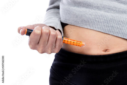a young woman injecting insulin into her stomach, injecting insulin photo