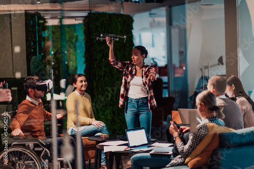 Business persons with a disability at work in modern open space coworking office on team meeting using virtual reality goggles.