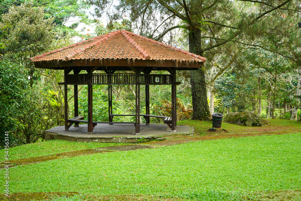 A gazebo for rest and shelter in a very large garden of grass and flowers. Thriving meadow. Taman Bunga Nusantara, Cianjur, West Java, Indonesia.