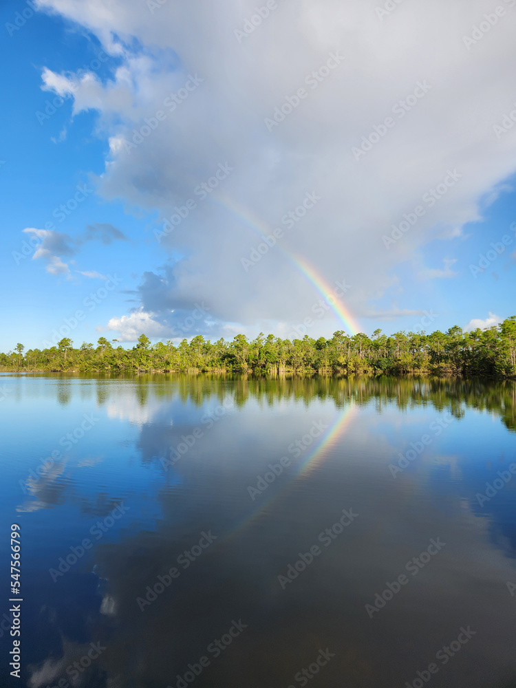 Rainbow and clouds over Pine Glades Lake in Everglades National Park, Florida on sunny autumn morning. Rainbow and clouds over Pine Glades Lake in Everglades National Park, Florida on sunny autumn morning.