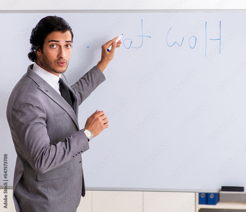 Young handsome businessman in front of whiteboard Young handsome businessman in front of whiteboard