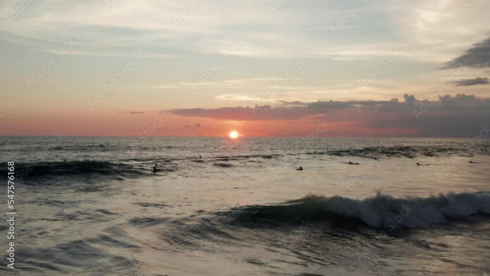 Aerial of people swimming in the ocean at sunset Aerial of people swimming in the ocean at sunset