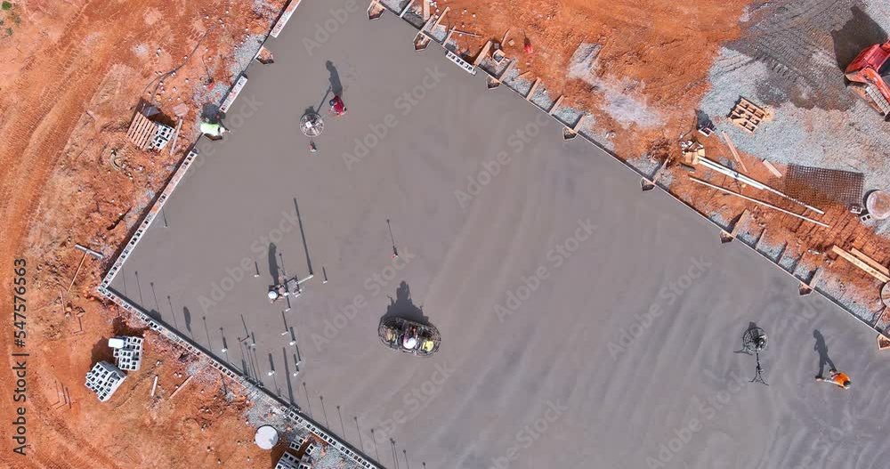 Process polishing and leveling cement screed mortar floors on construction site in process construction