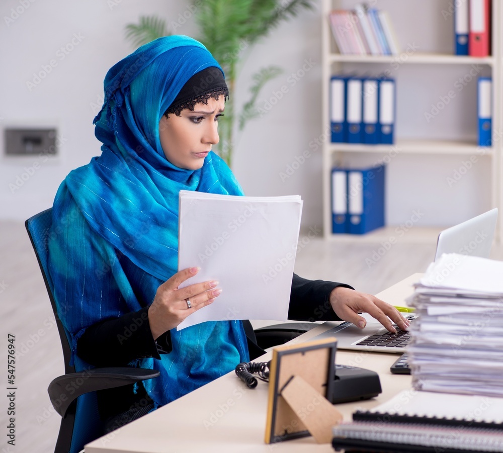 Female employee in hijab working in the office