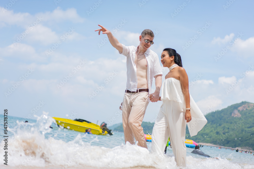 Obraz premium Romantic lovers young couple relaxing together on the tropical beach.Couple lover enjoy life.Summer vacations