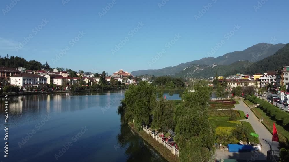 Beautiful drone shot of downtown center with lake buildings and mountains in East Asia Beautiful drone shot of downtown center with lake buildings and mountains in East Asia