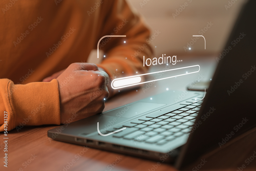 Man using laptop for download software and waiting to loading digital business data form website, concept of waiting for load of loading bar. - obrazy, fototapety, plakaty 