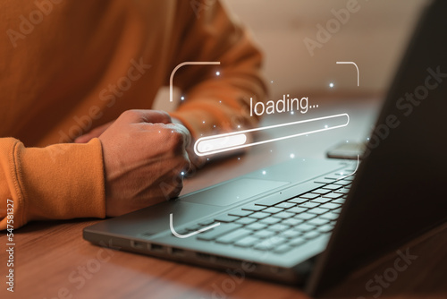 Man using laptop for download software and waiting to loading digital business data form website, concept of waiting for load of loading bar. photo