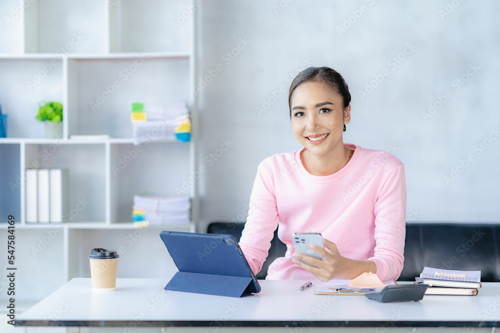 Asian woman working online with tablet Happy young woman working from home Asian woman working online with tablet Happy young woman working from home