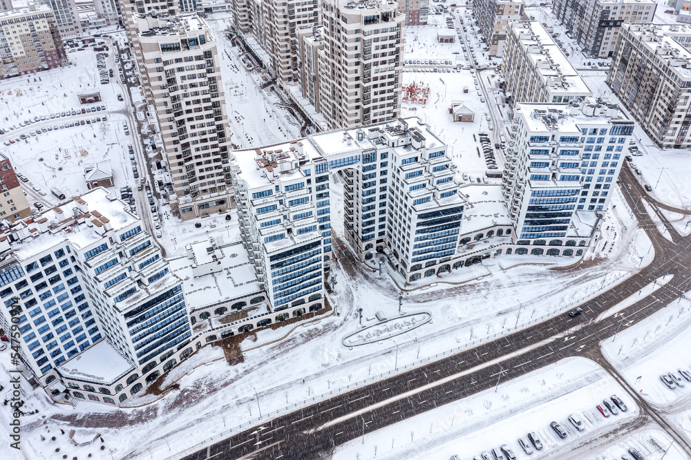 urban residential district in winter time during heavy snowfall. Minsk, Belarus. aerial drone view.