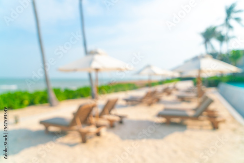 abstract blur umbrella with beach chair for background