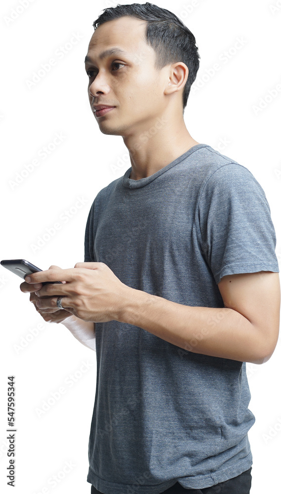 Young smiling handsome Asian man in casual attire using mobile phone isolated studio background Young smiling handsome Asian man in casual attire using mobile phone isolated studio background