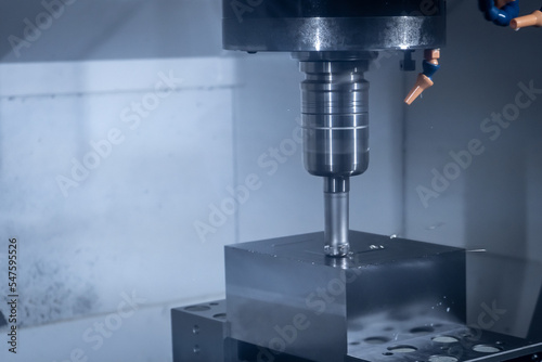 CNC machine tool cutting raw material in factory