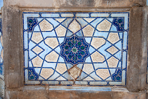 Traditional uzbek pattern on the ceramic tile on the wall of the mosque.