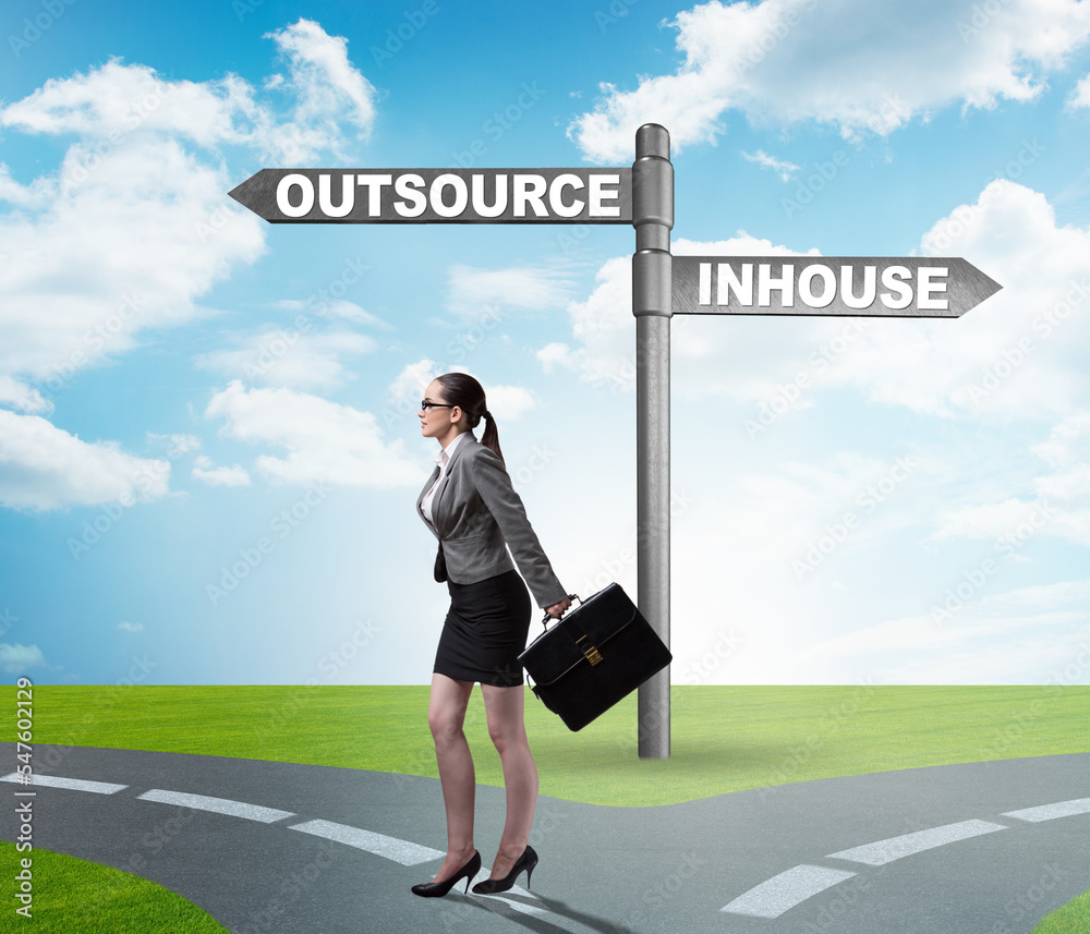 Businesswoman at crossroads deciding between outsourcing and inh Businesswoman at crossroads deciding between outsourcing and inh