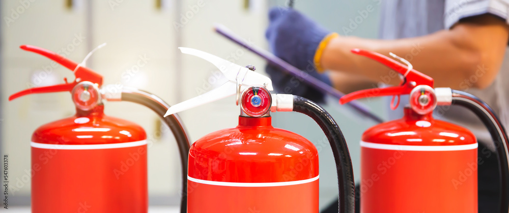 Fire extinguisher has hand engineer inspection checking pressure gauges to prepare fire equipment for protection and prevent in emergency case and safety or rescue and alarm system training concept. Fire extinguisher has hand engineer inspection checking pressure gauges to prepare fire equipment for protection and prevent in emergency case and safety or rescue and alarm system training concept.