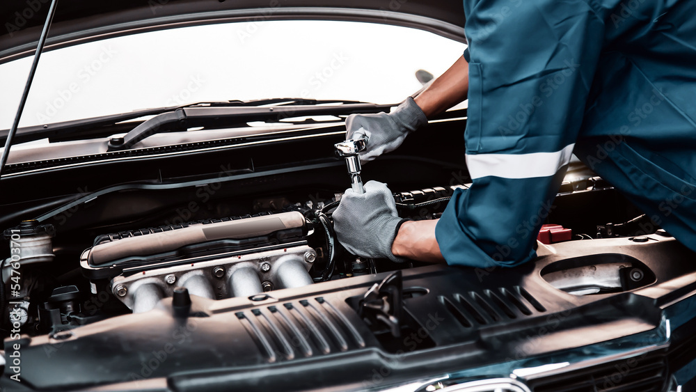 Car care maintenance and servicing, Close-up hand technician auto mechanic using the wrench to repairing change spare part car engine problem and car insurance service support. - obrazy, fototapety, plakaty 