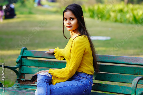 Indian female model sitting on the bench outdoor
