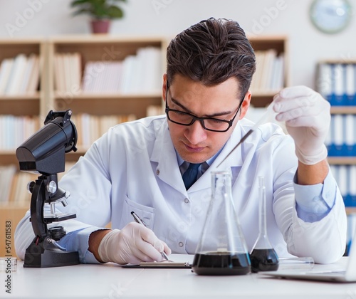 Chemical engineer working on oil samples in lab