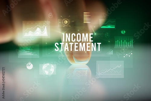 Finger touching tablet with business graphs and icons concept