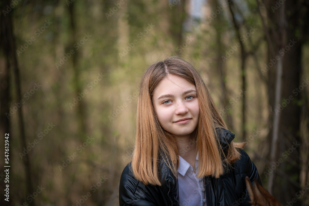 Portrait of a young beautiful woman in a dark autumn jacket.