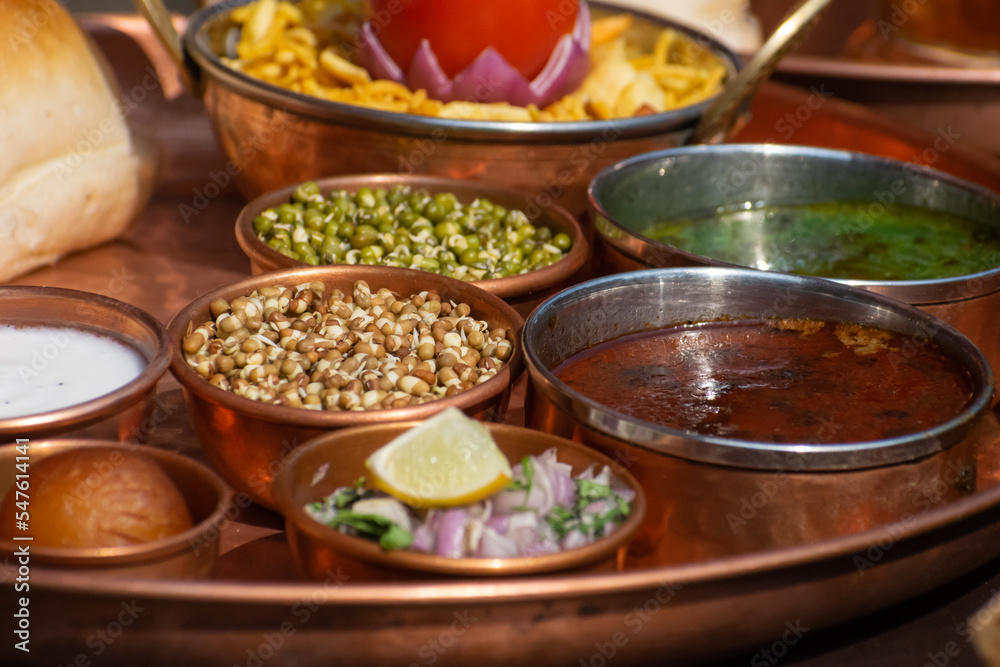 Famous maharashtrian cuisine, street food called misal pav which includes spicy curry, sprouts, snacks, bread, salad. Kolhapur, Nasik, Pune, Katakir, chutney, onion, rassa, tarri, farsan, lemon, junk