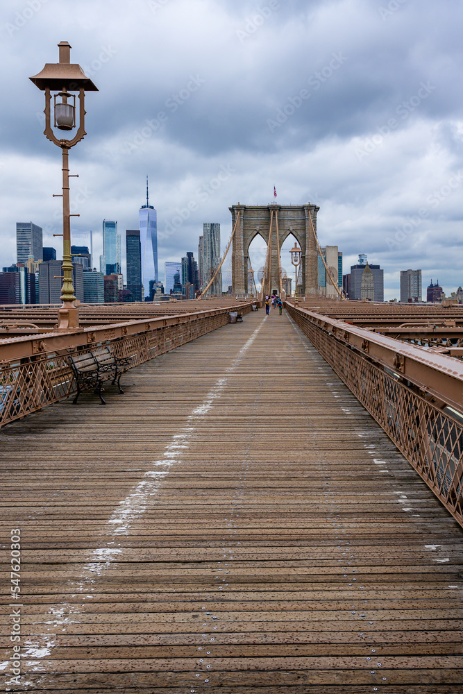 Brooklyn bridge with the rainy clouds in New York City.