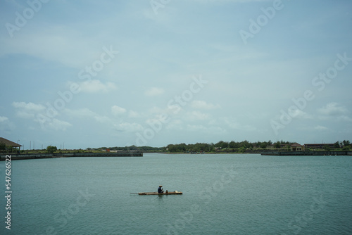 fisherman in the middle of the water © Fuad
