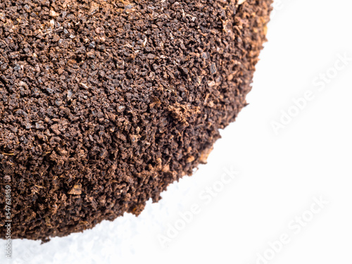 Ground coffee powder isolated on white background..Used coffee grounds after espresso machine and coffee beans on white  background.Caffeine addiction concept.