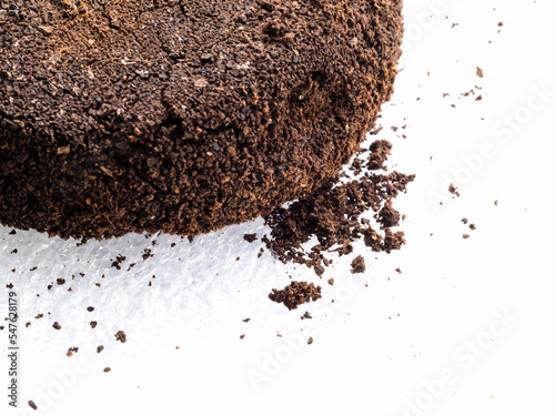 Ground coffee powder isolated on white background..Used coffee grounds after espresso machine and coffee beans on white  background.Caffeine addiction concept.