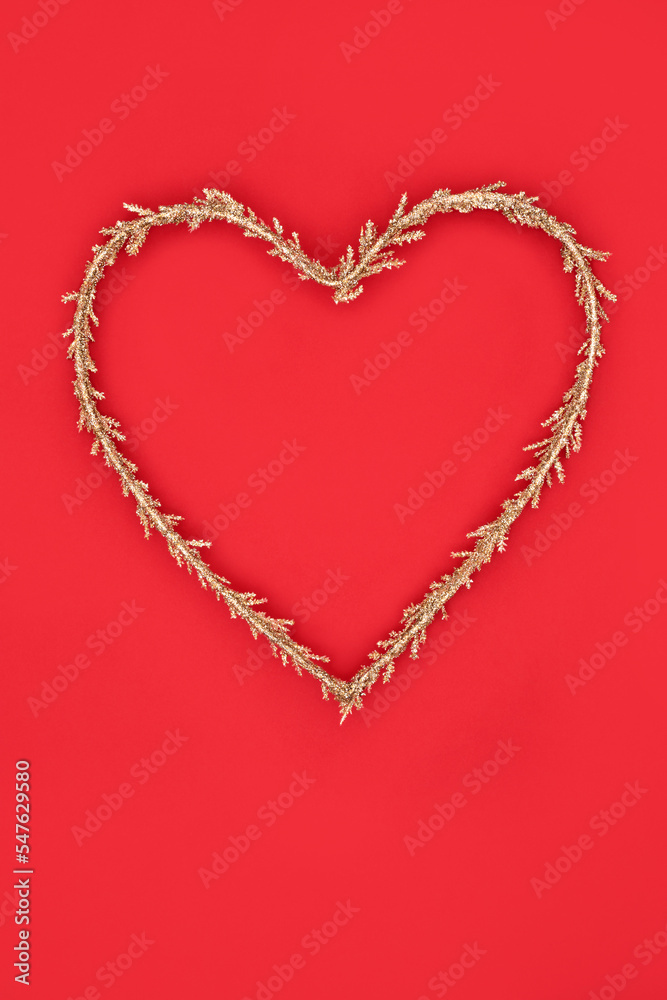 Christmas heart shape wreath gold glitter decoration. Symbol of love for festive Xmas and New Year holiday season and Valentines Day.