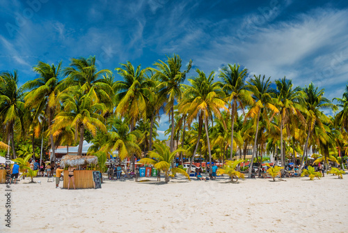 Cocos beach bar on a beach with white sand and palms on a sunny day, Isla Mujeres island, Caribbean Sea, Cancun, Yucatan, Mexico © Eagle2308