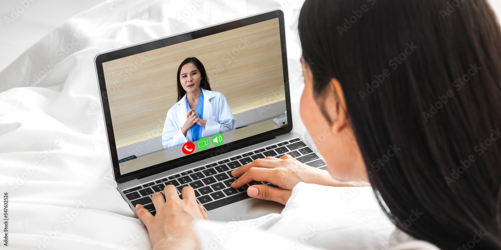 Woman talk speak using laptop computer and video conference online with doctor and stethoscope service help support team discussing and consulting talk video chat call checkup information at home Woman talk speak using laptop computer and video conference online with doctor and stethoscope service help support team discussing and consulting talk video chat call checkup information at home
