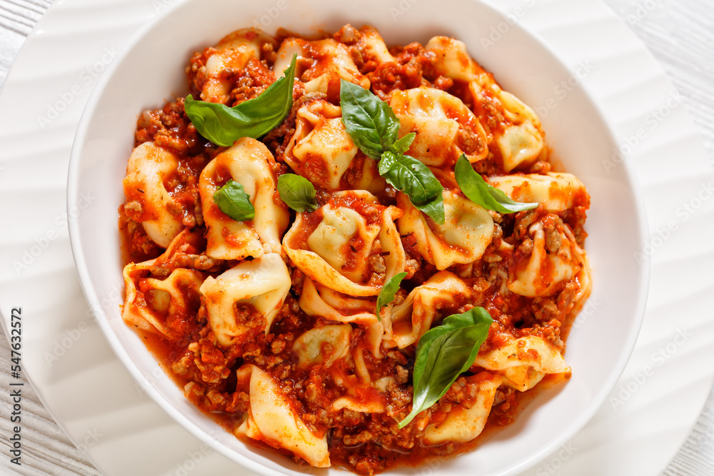 tortellini in ground beef tomato sauce, top view tortellini in ground beef tomato sauce, top view